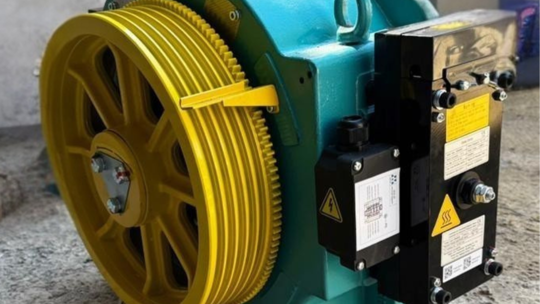 Máquina gearless instalada en ascensor, con técnico revisando